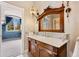 Charming bathroom vanity with vintage wood mirror and stylish sconce lighting at 6901 E 12Th Ave, Denver, CO 80220