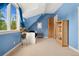 Cozy bedroom featuring a lofted ceiling and large windows with natural light at 6901 E 12Th Ave, Denver, CO 80220