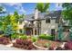 Stunning two-story home with lush landscaping, featuring a charming balcony, elegant architectural details, and mature trees at 6901 E 12Th Ave, Denver, CO 80220