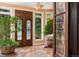 Elegant foyer featuring a large double door entrance, marble tile flooring, decorative glass, and abundant natural light at 6901 E 12Th Ave, Denver, CO 80220