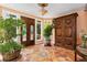Expansive foyer with custom double doors, large windows, and a statement cabinet piece, providing a grand entrance at 6901 E 12Th Ave, Denver, CO 80220