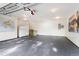 Spacious garage with painted floor, white walls, world map and mountain art at 6901 E 12Th Ave, Denver, CO 80220