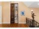 Elegant hallway showcasing hardwood floors, an ornate doorway, and a detailed bronze statue at 6901 E 12Th Ave, Denver, CO 80220
