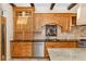 Elegant kitchen features custom wood cabinets, tiled backsplash, and granite counters at 6901 E 12Th Ave, Denver, CO 80220