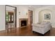 Comfortable living room with hardwood floors, a fireplace, and seamless transitions to other elegant living areas at 6901 E 12Th Ave, Denver, CO 80220