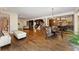 Expansive open floor plan with hardwood, connecting living, dining, and kitchen spaces at 6901 E 12Th Ave, Denver, CO 80220