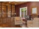 Cozy seating area with custom built-ins, a window, and rich woodwork at 6901 E 12Th Ave, Denver, CO 80220