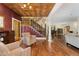 Grand living room featuring a decorative staircase and hardwood floors at 6901 E 12Th Ave, Denver, CO 80220