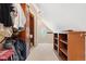 Spacious walk-in closet with custom shelves, cabinets, and oval window at 6901 E 12Th Ave, Denver, CO 80220