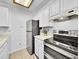 Bright kitchen features stainless steel appliances, ample cabinet space, and neutral countertops at 14751 E Tennessee Dr # 225, Aurora, CO 80012