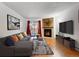 Cozy living room featuring a fireplace, balcony access, stylish decor, and comfortable seating at 14751 E Tennessee Dr # 225, Aurora, CO 80012