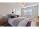 Comfortable bedroom featuring a cozy bed, modern decor, and natural light at 382 S Decatur St, Denver, CO 80219