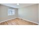 Cozy bedroom with hardwood floors, a large window, and neutral paint at 382 S Decatur St, Denver, CO 80219