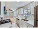 Modern kitchen with stainless steel appliances, white cabinets, and ample counter space at 382 S Decatur St, Denver, CO 80219