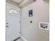 Mud room, featuring a white door, neutral paint, and appliances at 382 S Decatur St, Denver, CO 80219