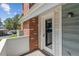 Back porch featuring brick and gray-toned paneling with a white-trimmed glass back door at 262 S Nome St, Aurora, CO 80012
