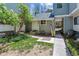 Charming front entrance of home with gray siding, a white door, and a small, well-maintained yard at 262 S Nome St, Aurora, CO 80012
