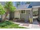 Charming front entrance of home with gray siding, a white door, and a small, well-maintained yard at 262 S Nome St, Aurora, CO 80012