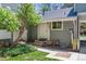 Charming front entrance of home with gray siding, a white door, and a small, well-maintained yard at 262 S Nome St, Aurora, CO 80012
