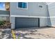 A gray garage door with gray-tone siding and a concrete drive at 262 S Nome St, Aurora, CO 80012