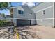 View of the house featuring an attached garage and blue siding at 262 S Nome St, Aurora, CO 80012