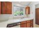 Kitchen featuring a large sink, wood cabinets, and a bright window with outdoor views at 262 S Nome St, Aurora, CO 80012