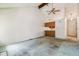 Living room featuring high ceilings with a ceiling fan and adjacent kitchen area with wood cabinets at 262 S Nome St, Aurora, CO 80012