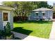 Green grass backyard with detached garage and walkway at 2354 S Ogden St, Denver, CO 80210