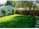 Landscaped backyard with spacious lawn, stone pathway, and mature trees at 2354 S Ogden St, Denver, CO 80210