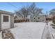 Detached garage and snowy backyard with a walkway at 2354 S Ogden St, Denver, CO 80210