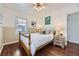 Well-lit bedroom featuring a wood bed frame and nightstand at 2354 S Ogden St, Denver, CO 80210