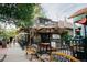 Outdoor seating area of a coffee shop with umbrellas and benches at 2354 S Ogden St, Denver, CO 80210