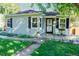 Light blue house with black shutters, green lawn, and walkway at 2354 S Ogden St, Denver, CO 80210