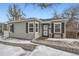 Gray house with black shutters, snowy front yard, and walkway at 2354 S Ogden St, Denver, CO 80210