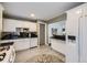 Kitchen features white cabinets, granite counters, and stainless steel appliances at 2354 S Ogden St, Denver, CO 80210