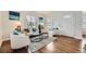 Living room with hardwood floors, white couch, and two armchairs at 2354 S Ogden St, Denver, CO 80210