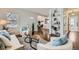 Living room with hardwood floors, white couch, and built-in shelves at 2354 S Ogden St, Denver, CO 80210