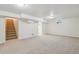 Spacious finished basement with carpet and access to stairs and additional rooms at 6193 Holland St, Arvada, CO 80004
