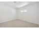 Empty bedroom with neutral carpet, window, and ample natural light at 6193 Holland St, Arvada, CO 80004