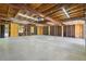 Spacious unfinished garage interior featuring exposed beams, ample lighting, and a concrete floor at 6193 Holland St, Arvada, CO 80004