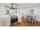 Modern kitchen featuring stainless steel appliances and stylish range hood at 6193 Holland St, Arvada, CO 80004