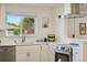 Updated kitchen featuring stainless steel appliances and white cabinetry at 6193 Holland St, Arvada, CO 80004