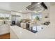 Bright kitchen featuring stainless steel appliances, white countertops, and ample storage at 6193 Holland St, Arvada, CO 80004