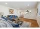Open-concept living room with hardwood floors and seamless flow into the kitchen at 6193 Holland St, Arvada, CO 80004