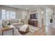 This living room features wood floors, a comfortable L-shaped sofa, and built in cabinets with modern decor at 1188 Sugarloaf Ln, Erie, CO 80516