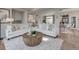 Open-concept living room with comfortable seating and seamless access to the dining and kitchen areas at 1188 Sugarloaf Ln, Erie, CO 80516