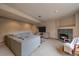 Inviting finished basement with comfortable seating near a fireplace and entertainment center at 13472 Monroe St, Thornton, CO 80241