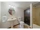 Bathroom features a pedestal sink, toilet, and shower at 13472 Monroe St, Thornton, CO 80241