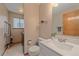 Cozy bathroom with a sleek vanity, modern toilet and a convenient laundry area at 13472 Monroe St, Thornton, CO 80241