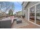Inviting outdoor patio with cozy seating, grill, and sliding glass door at 13472 Monroe St, Thornton, CO 80241